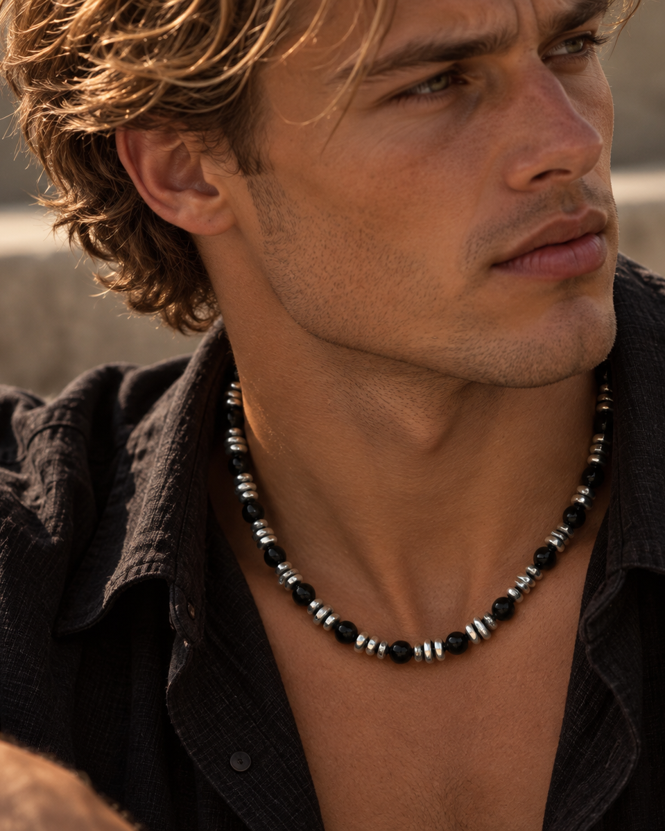 Axel men's necklace worn by a man in sunlight