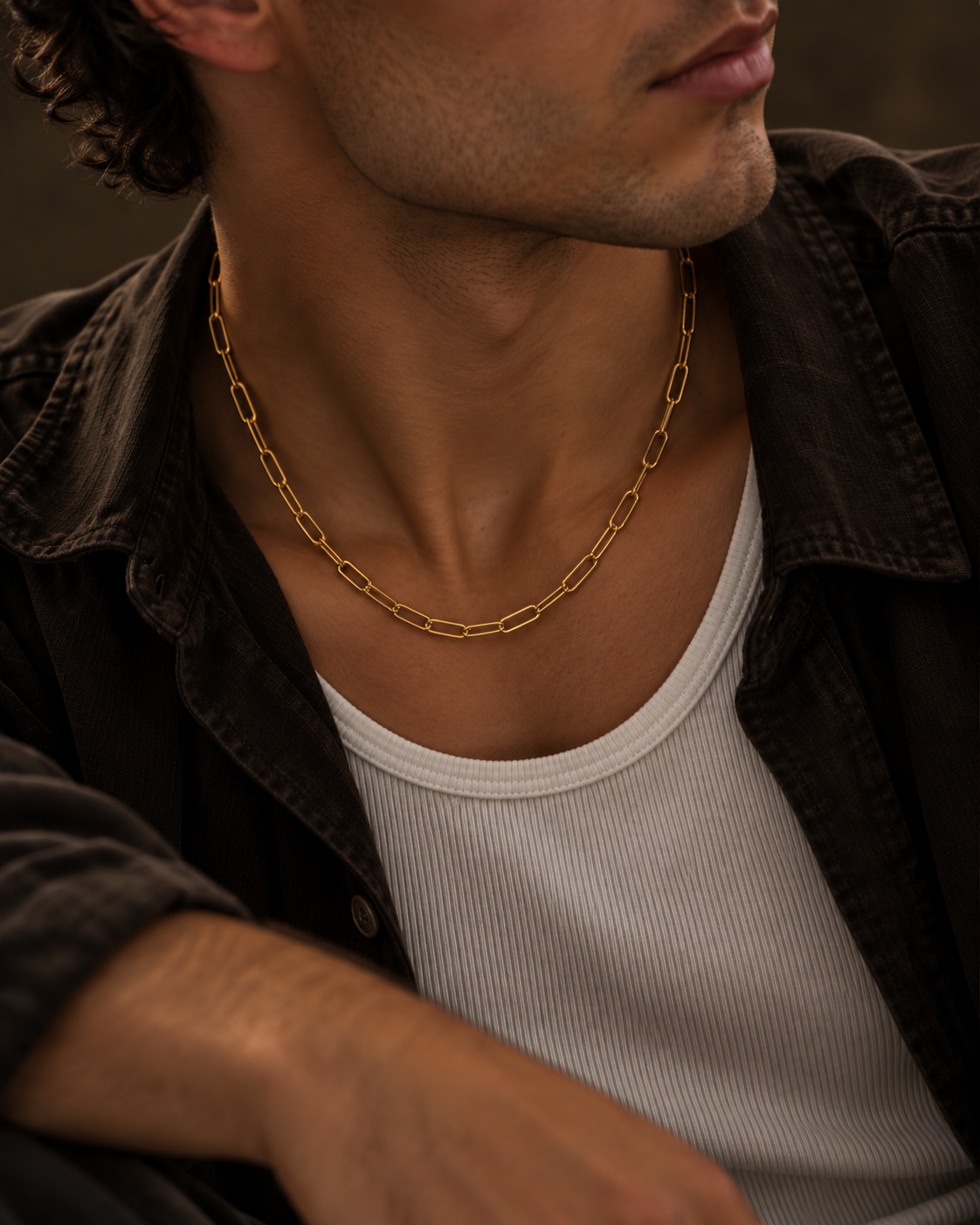 Cure gold-plated men's necklace in warm portrait light