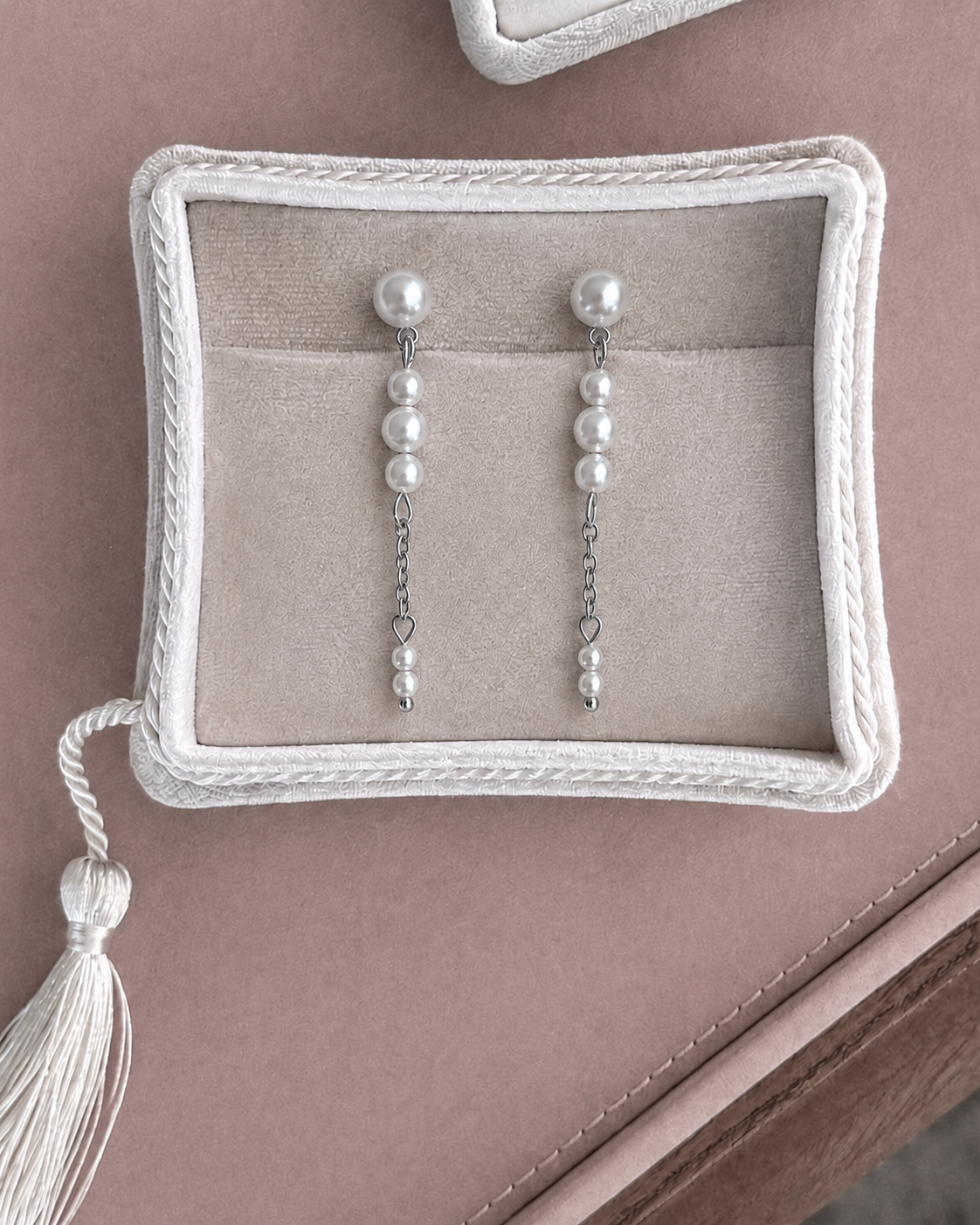 The silver version of the Evania earrings with pearls in graduated sizes