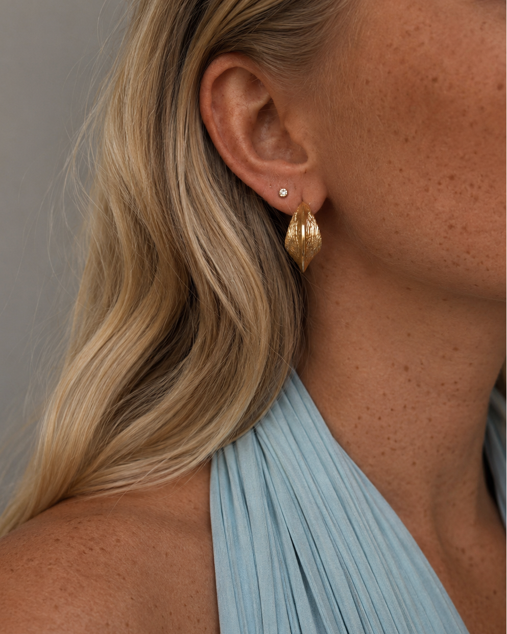 Gold-plated Iris statement earrings with curved, sculptural shape