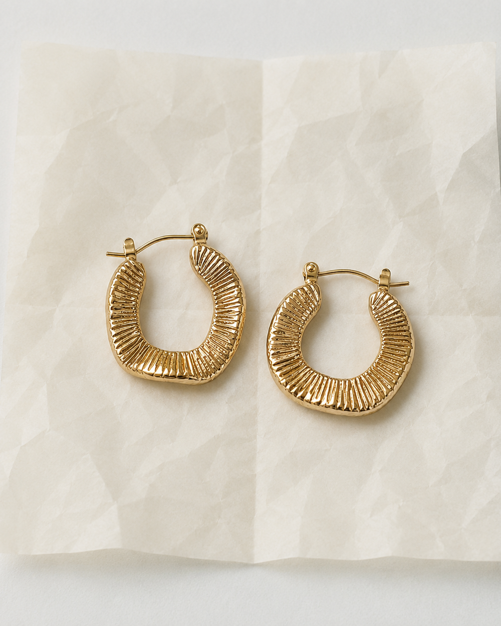Gold-plated Mirage hoops with sculptural look