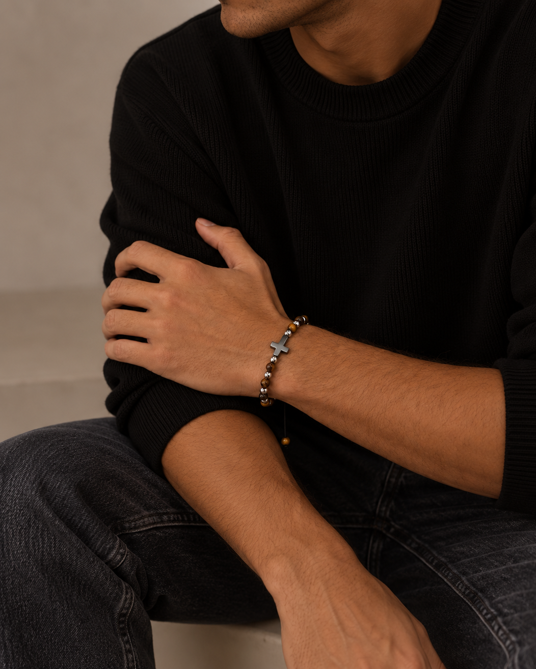 Detail of Saint men's bracelet with silver-coloured cross and natural stones