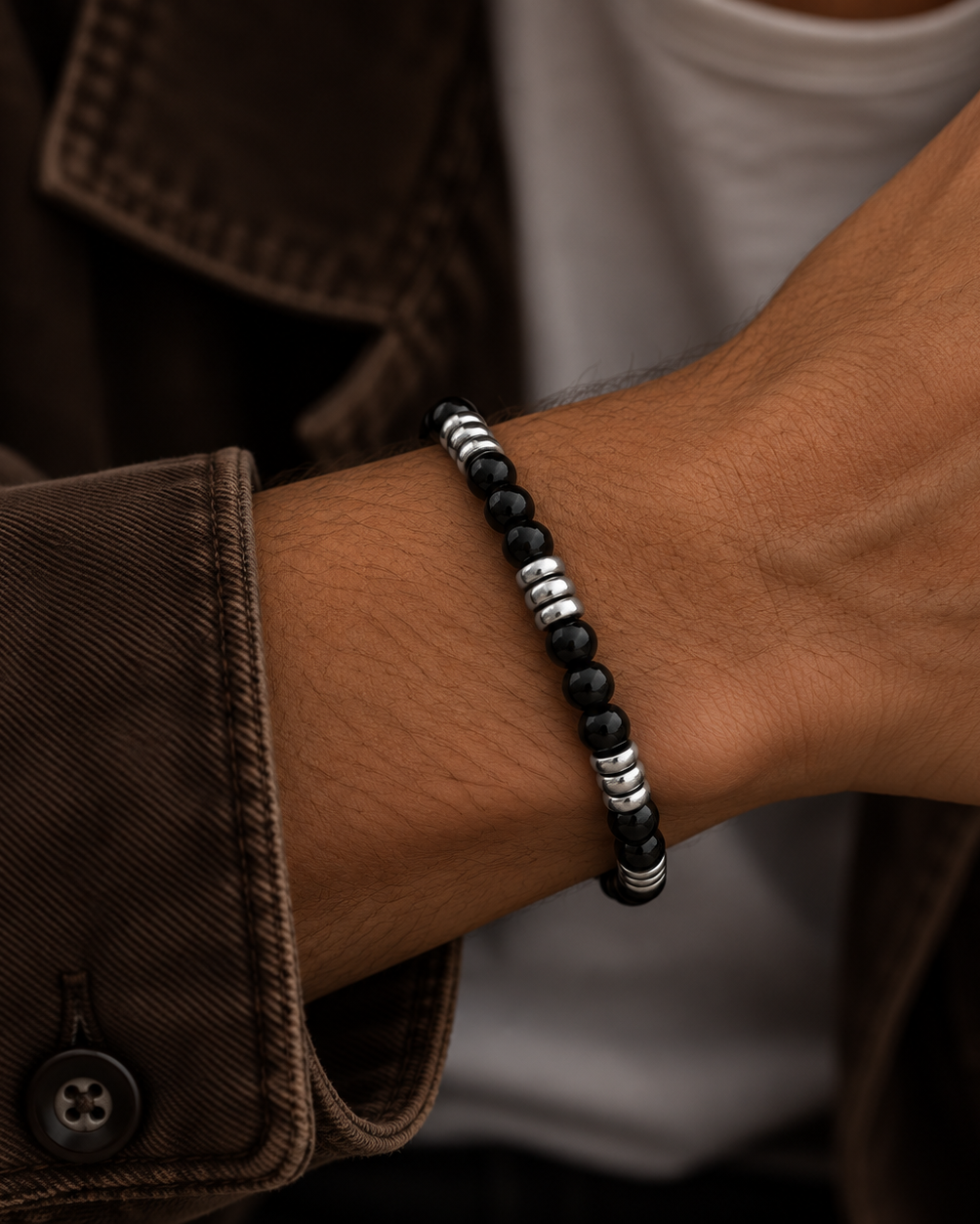 Detail of Santos black men's bracelet with contrast between stone and steel