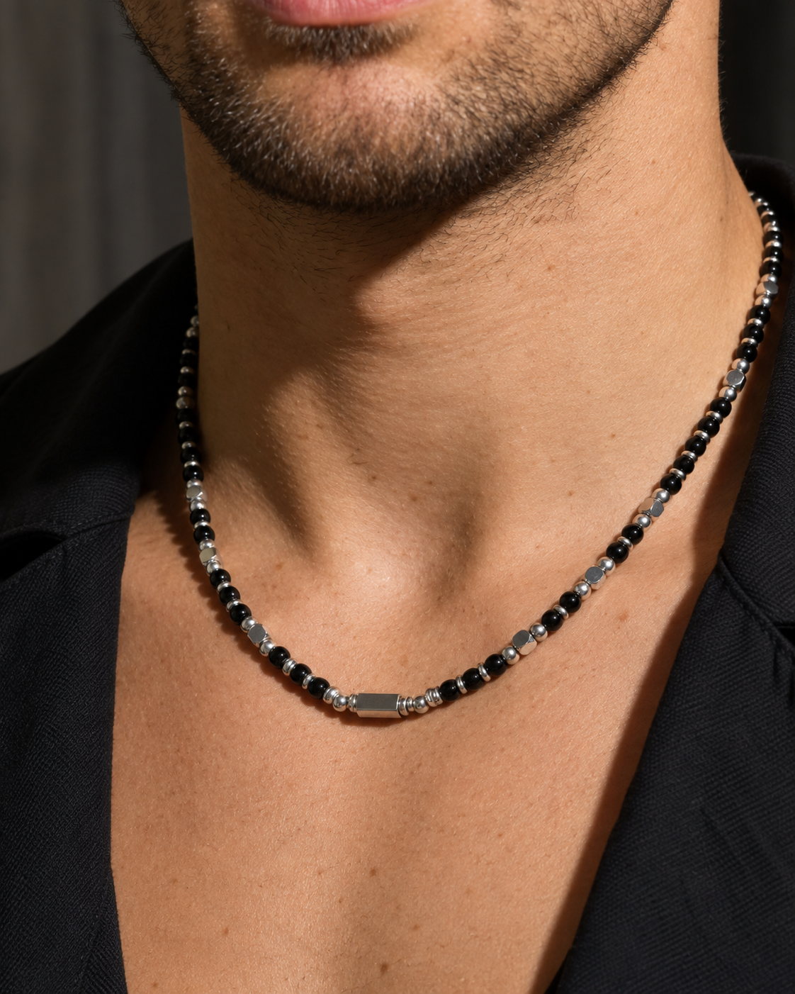 Close-up of Zayn necklace with black stones at the neck