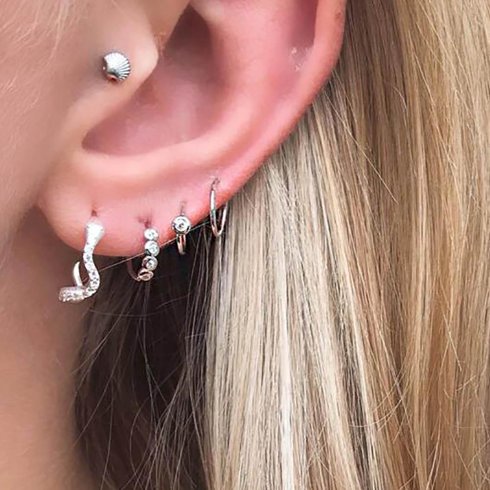 Petite Crystal Hoop is a timeless style with a single clear cubic zirconia. The earring has no backstopper which makes it comfortable to wear. To open it, you just twist it a bit. It's a beautiful earring by itself but can perfectly be styled with our other petite hoops to create a cool look. 