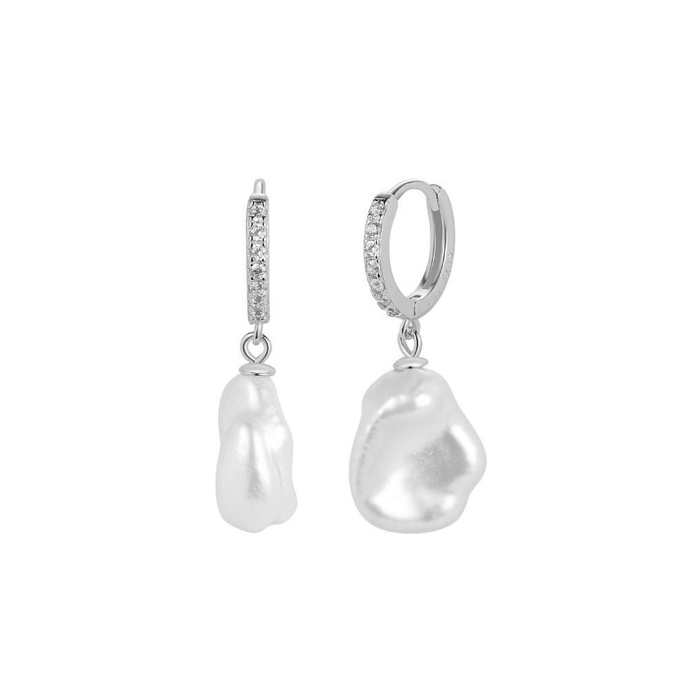Celine Earrings are beautiful and elegant huggie earrings with a irregular freshwater pearl and clear cubic zirconia. The earrings are easy to put in because of the huggie style. Use it alone to create an elegant look or use together with other earrings as some of our ear cuffs. 