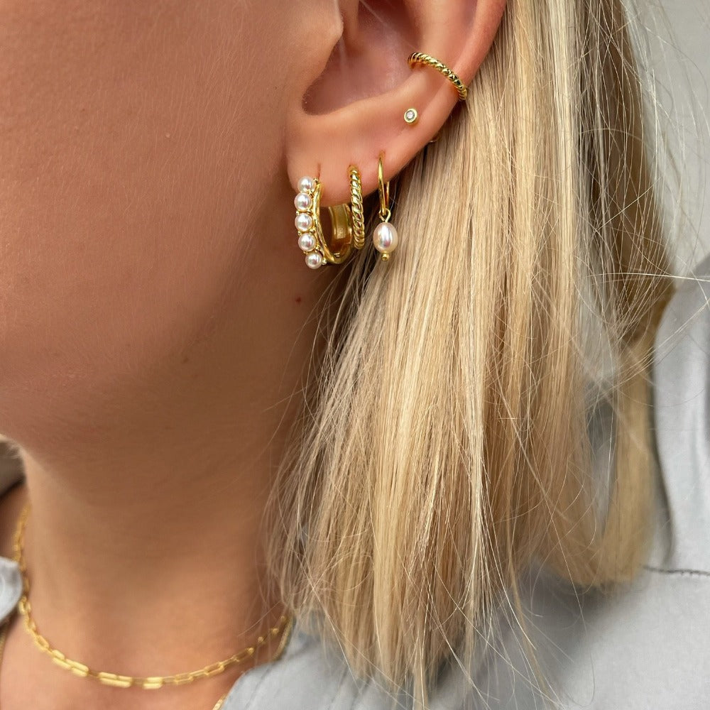 Hush Earring is a classic hoop with twisted details. The earrings are perfect for everyday use because of it's size and cute details. Use it alone or style it with other hoops to create a unique look.